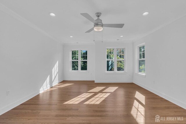 empty room featuring ornamental molding, hardwood / wood-style floors, and ceiling fan