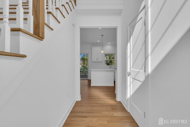 hallway with light wood-type flooring