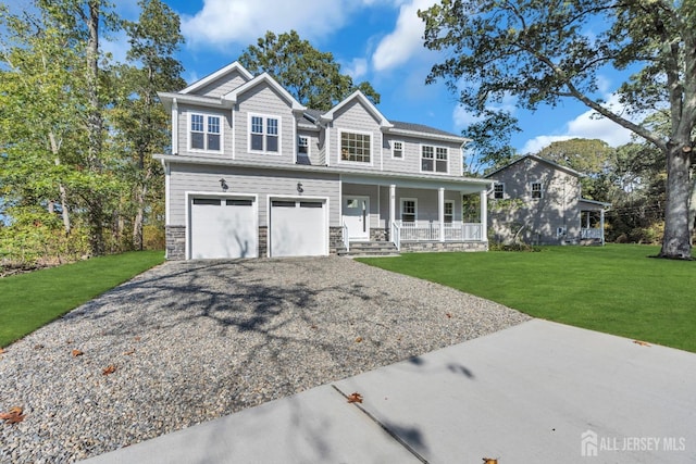 view of front facade featuring covered porch, a garage, and a front lawn