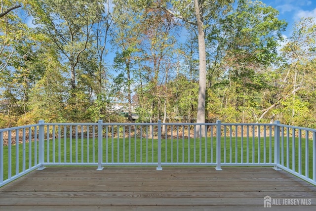 wooden terrace featuring a yard