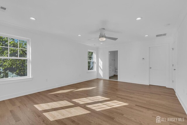 unfurnished room with light hardwood / wood-style flooring, ceiling fan, crown molding, and a wealth of natural light