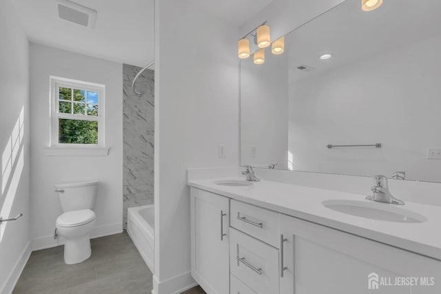 full bathroom with vanity, tiled shower / bath combo, and toilet