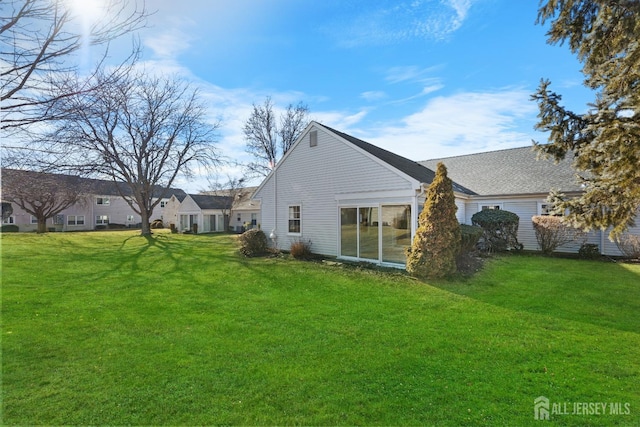 rear view of house with a yard