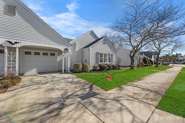 view of home's exterior with concrete driveway, a lawn, and an attached garage