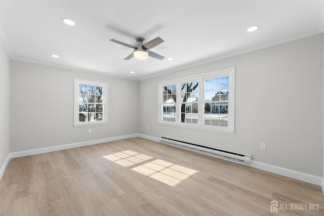 spare room with recessed lighting, a baseboard heating unit, baseboards, ornamental molding, and light wood finished floors