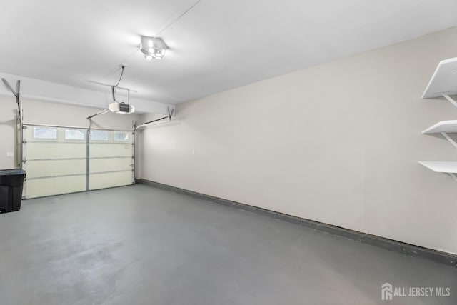 garage with baseboards and a garage door opener