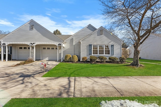 view of front of home with an attached garage, a front lawn, and concrete driveway