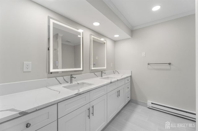 full bathroom featuring double vanity, a baseboard radiator, a sink, and crown molding