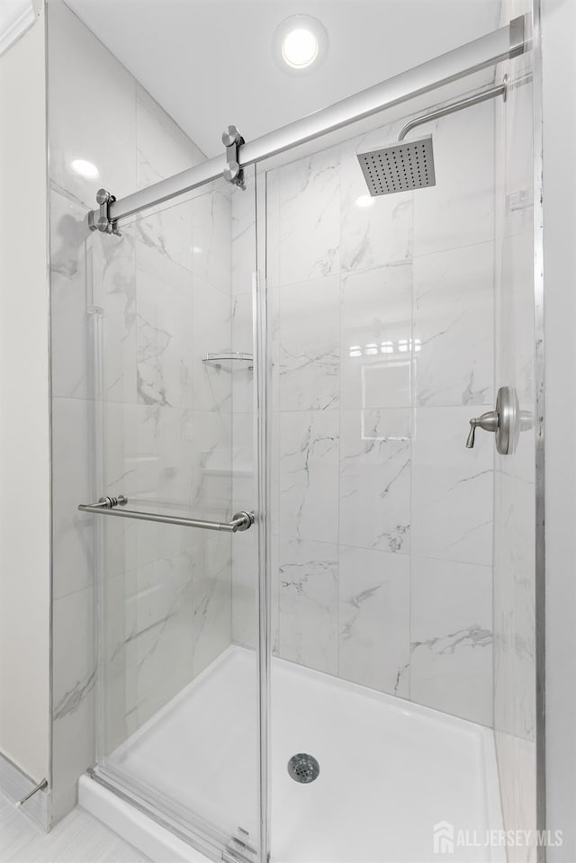 full bath with a marble finish shower