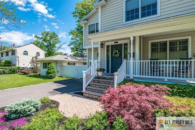22 Kentnor St, Metuchen, NJ 08840 - view of exterior entry with covered porch, driveway, and a yard