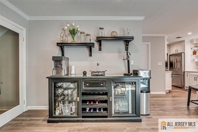 22 Kentnor St, Metuchen, NJ 08840 - indoor dry bar featuring stainless steel fridge, crown molding, recessed lighting, light wood finished floors, and wine cooler