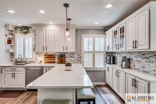 22 Kentnor St, Metuchen, NJ 08840 - kitchen featuring stainless steel dishwasher, a sink, open shelves, dark wood finished floors, and a peninsula