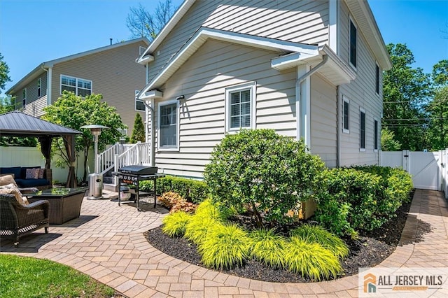 22 Kentnor St, Metuchen, NJ 08840 - view of side of home with a gazebo, a gate, a patio area, and outdoor lounge area