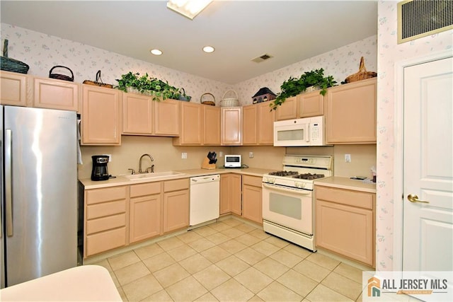 525 Harrier Dr Unit 525, Monroe, NJ 08831 - kitchen featuring white appliances, a sink, wallpapered walls, light brown cabinets, and light tile patterned floors