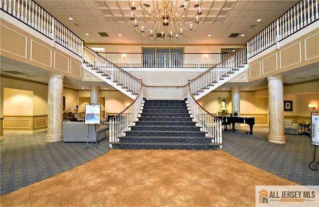 525 Harrier Dr Unit 525, Monroe, NJ 08831 - lobby featuring a towering ceiling, a decorative wall, stairs, a wainscoted wall, and recessed lighting