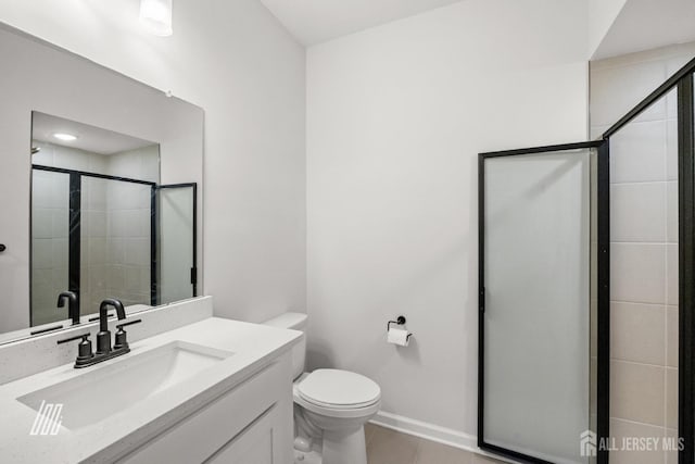 bathroom featuring a shower with shower door, tile patterned floors, vanity, and toilet