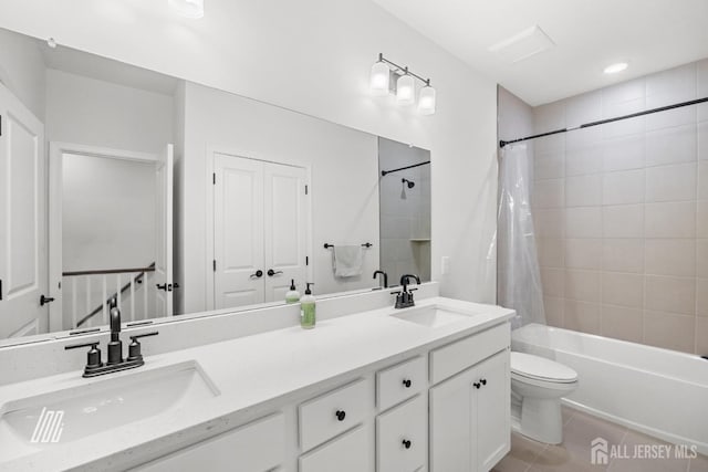 full bathroom with toilet, tile patterned flooring, vanity, and shower / tub combo with curtain