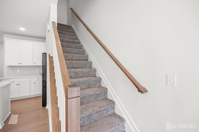 stairway featuring hardwood / wood-style floors