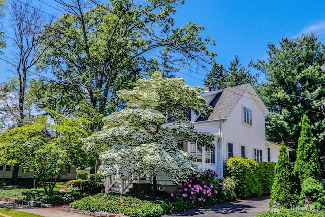 217 Midland Ave, Metuchen, NJ 08840 - view of side of home with a chimney and roof with shingles