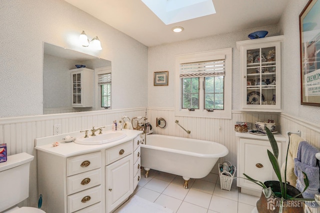 217 Midland Ave, Metuchen, NJ 08840 - full bath with a skylight, a wainscoted wall, a freestanding bath, tile patterned floors, and vanity