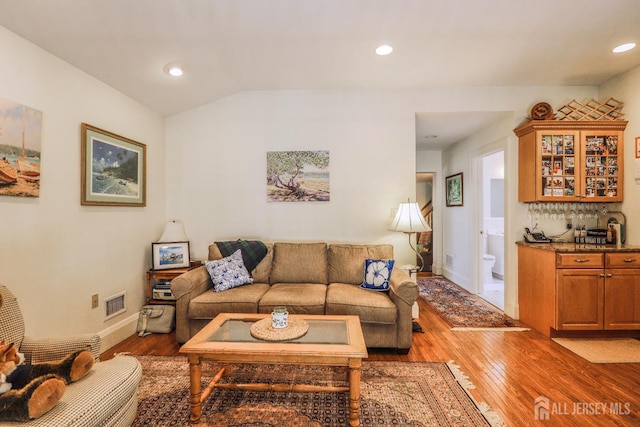 217 Midland Ave, Metuchen, NJ 08840 - living area featuring bar with sink, wood finished floors, vaulted ceiling, recessed lighting, and baseboards