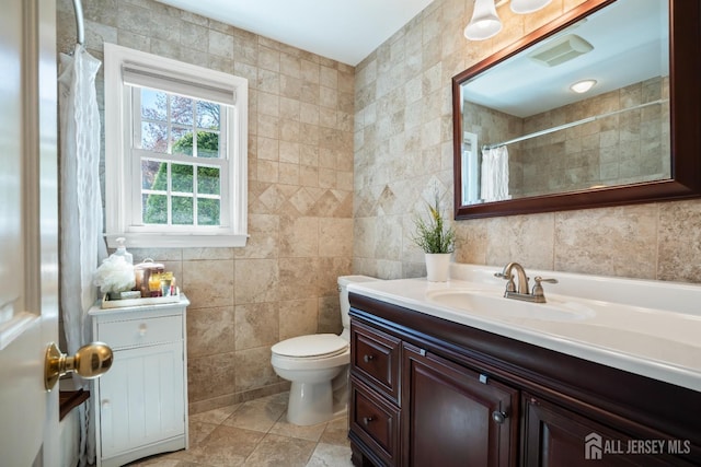 bathroom featuring tile walls, vanity, tile patterned floors, toilet, and a shower with shower curtain