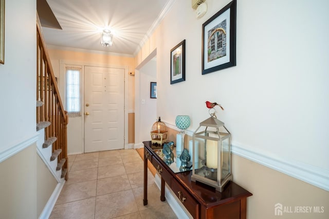 entrance foyer featuring stairs, crown molding, and light tile patterned floors