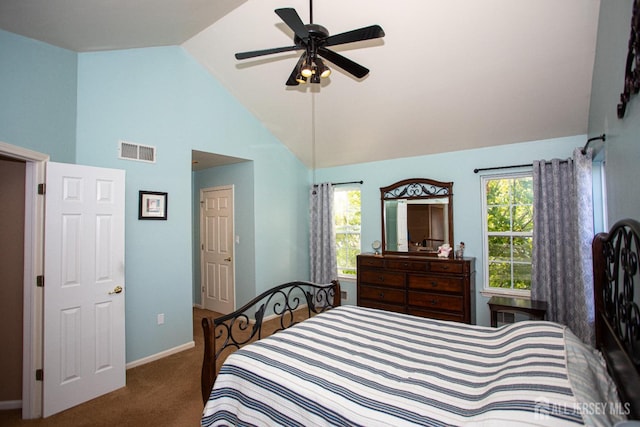 bedroom with ceiling fan, dark carpet, multiple windows, and lofted ceiling