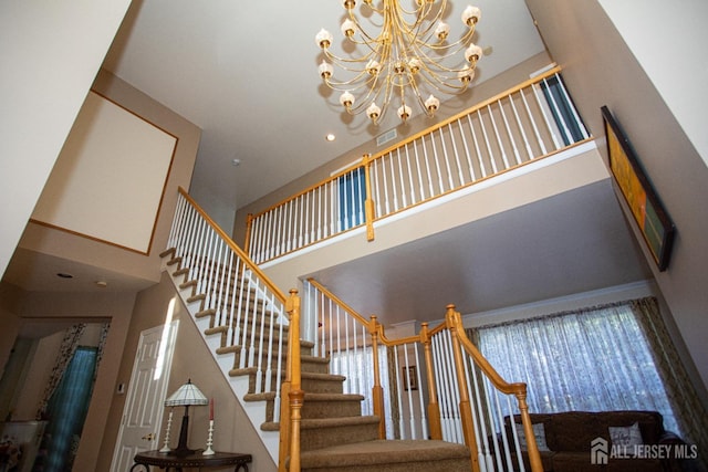 stairs with a towering ceiling and a chandelier