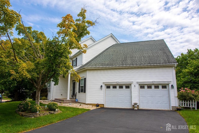 view of front of property featuring a garage and a front lawn