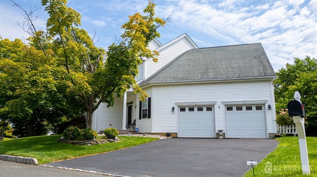 front of property with a garage and a front lawn