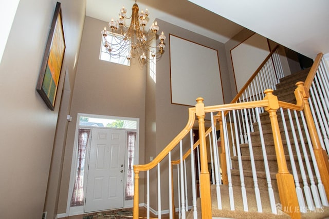 foyer with a notable chandelier and a towering ceiling