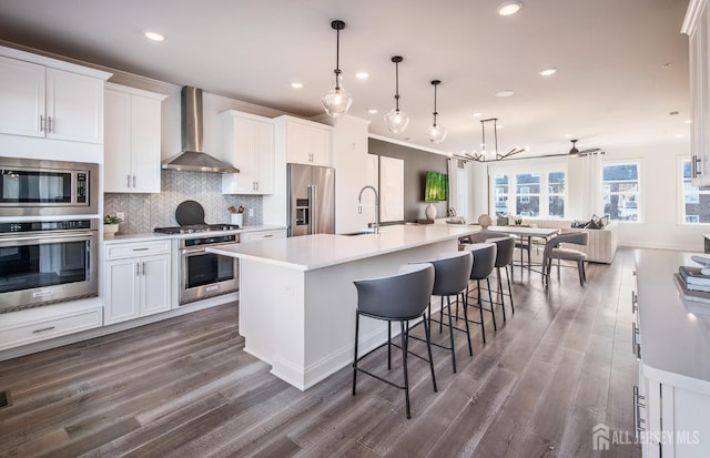 302 Nash Ave, West Windsor, NJ 08550 - kitchen with wall chimney range hood, appliances with stainless steel finishes, a sink, dark wood finished floors, and tasteful backsplash