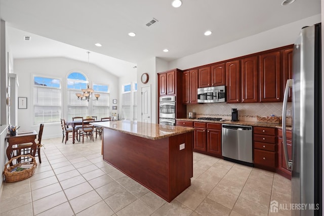 1 Jester Ct, Monroe, NJ 08831 - kitchen featuring stainless steel appliances, lofted ceiling, light stone counters, backsplash, and a center island