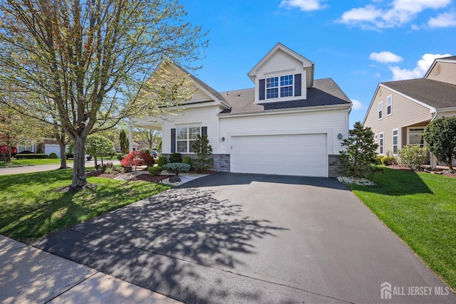1 Jester Ct, Monroe, NJ 08831 - view of front of house with asphalt driveway, stone siding, and a front yard