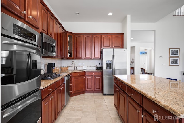 1 Jester Ct, Monroe, NJ 08831 - kitchen with stainless steel appliances, a sink, glass insert cabinets, light stone countertops, and recessed lighting