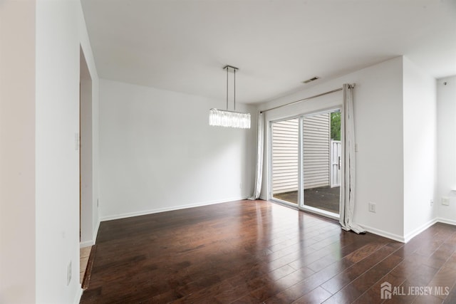 44 Treat Ln, East Brunswick, NJ 08816 - spare room featuring dark wood-style flooring and a chandelier