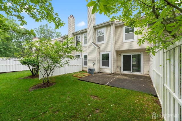 44 Treat Ln, East Brunswick, NJ 08816 - back of property with a chimney and a patio area