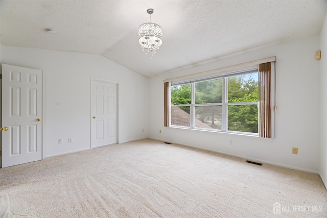 44 Treat Ln, East Brunswick, NJ 08816 - unfurnished bedroom with lofted ceiling, carpet flooring, and a chandelier