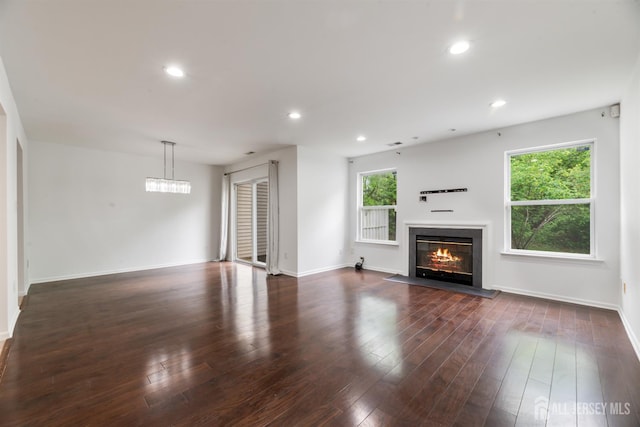 44 Treat Ln, East Brunswick, NJ 08816 - unfurnished living room with a glass covered fireplace, dark wood finished floors, and recessed lighting