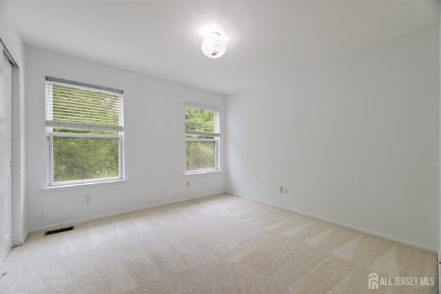 44 Treat Ln, East Brunswick, NJ 08816 - empty room featuring light colored carpet and baseboards