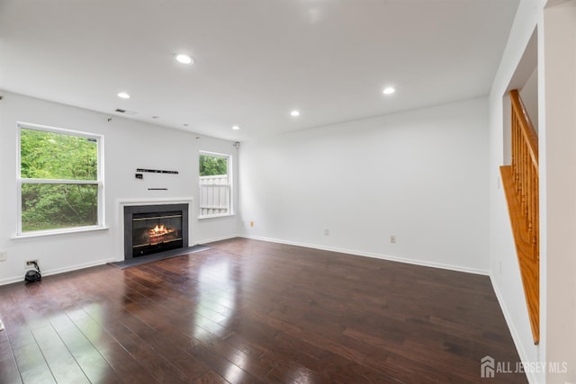 44 Treat Ln, East Brunswick, NJ 08816 - unfurnished living room with a glass covered fireplace, dark wood-style floors, and recessed lighting