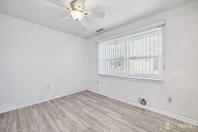 empty room featuring light wood-style floors, ceiling fan, visible vents, and baseboards