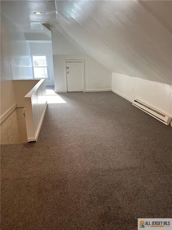 425 John St, Plainfield, NJ 07060 - bonus room with baseboard heating, vaulted ceiling, and carpet flooring