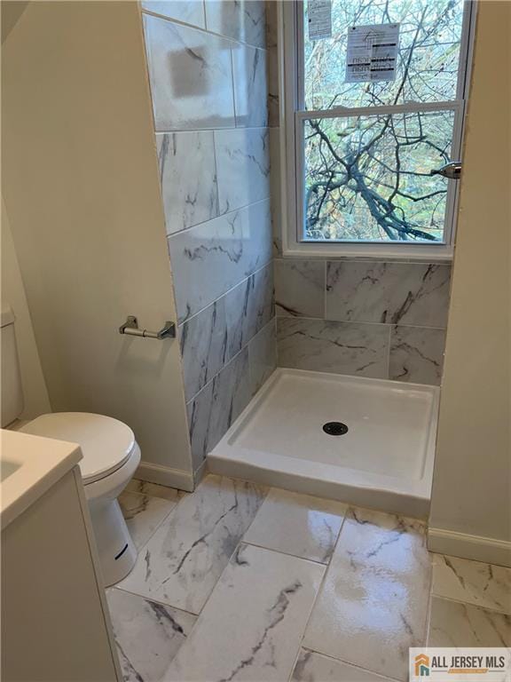 425 John St, Plainfield, NJ 07060 - bathroom featuring baseboards, marble look tiles, a shower stall, toilet, and vanity