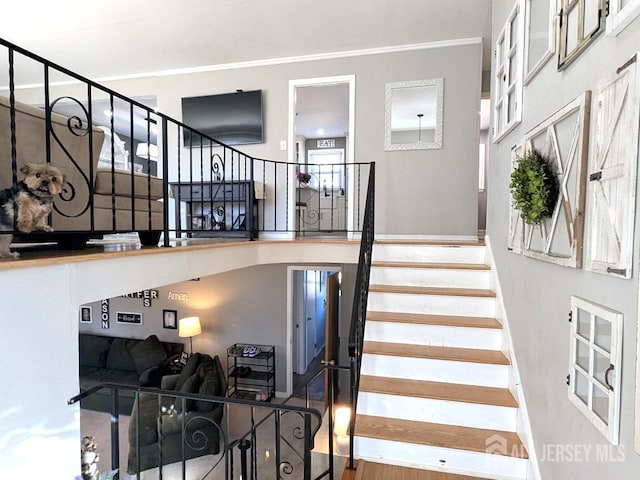 stairs featuring wood finished floors