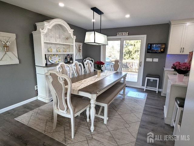 dining area featuring baseboards, recessed lighting, and dark wood finished floors