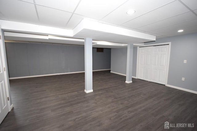 finished below grade area with recessed lighting, baseboards, and dark wood-type flooring