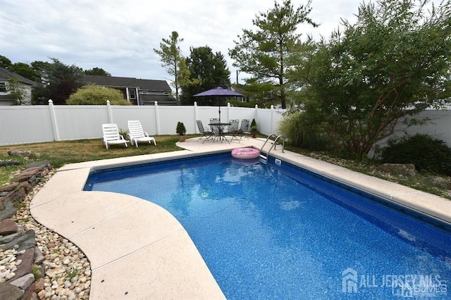 view of pool featuring a fenced in pool, a patio, a fenced backyard, and outdoor dining space