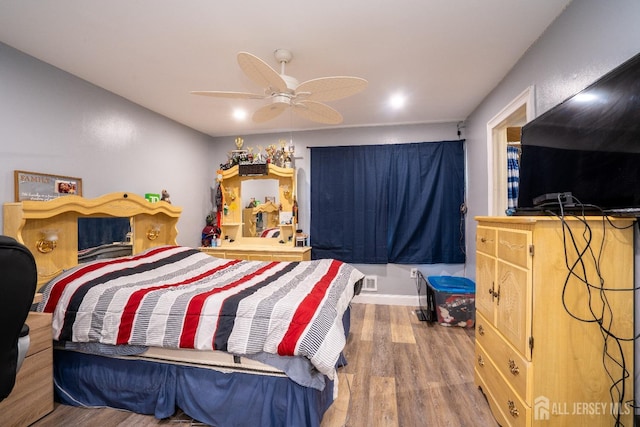 bedroom with a ceiling fan and wood finished floors